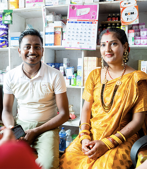 A man and woman sitting in a pharmacy