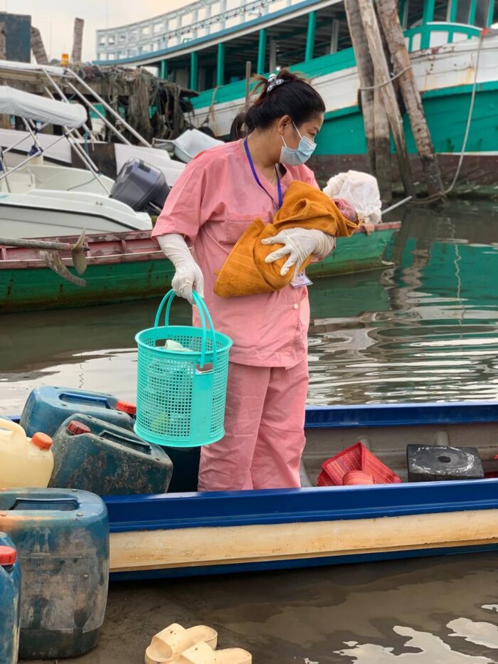 Tlang Sotheavy tends to Chhan Saleong’s baby in boat.