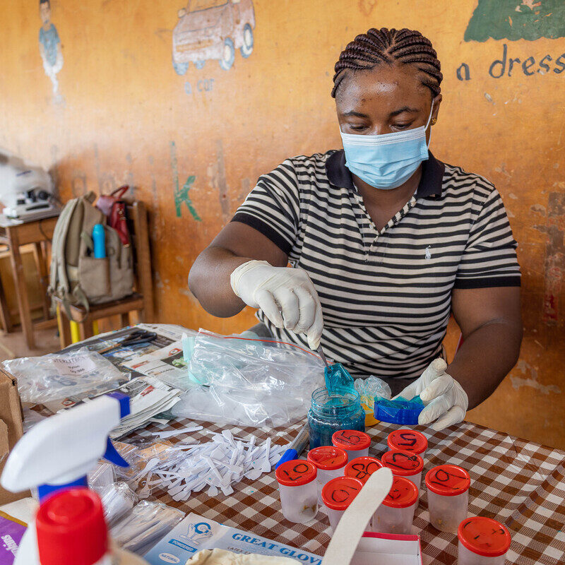 laboratory technician preparing slides for study.