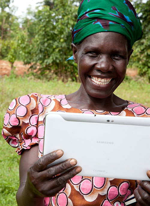 Woman smiling holding tablet computer