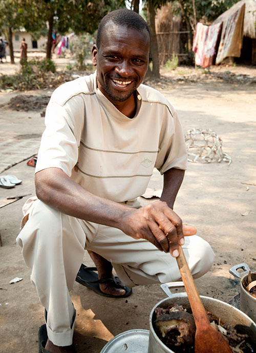 Man cooking for his family in Mozambique